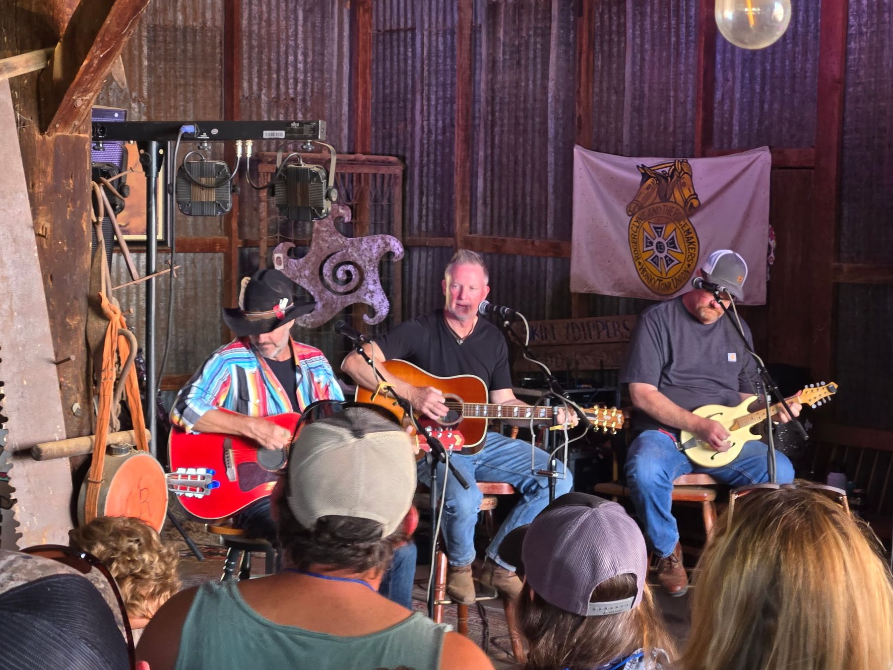 Three-piece acoustic set in a barn at Clyne Campout